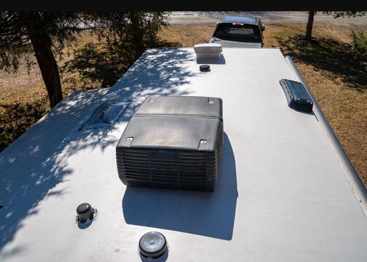 RV rooftop AC unit being repaired by certified technician in Fort Pierce FL